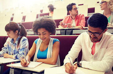 Image showing group of students with notebooks in lecture hall