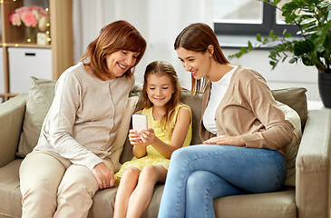 Image showing mother, daughter and grandmother with smartphone