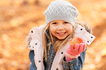 Image showing happy little girl with apple at autumn park