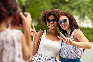 Image showing woman photographing her friends in summer park