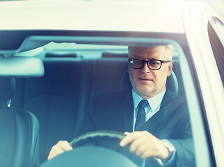 Image showing happy senior businessman driving car