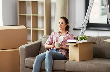 Image showing woman moving to new home and drinking coffee