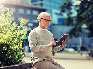 Image showing senior man with tablet pc on city street