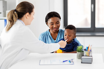 Image showing doctor examining african baby\'s mouth at clinic