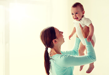 Image showing happy young mother with little baby at home