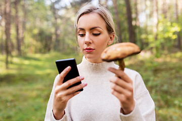 Image showing woman using smartphone to identify mushroom