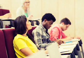 Image showing group of students with notebooks in lecture hall