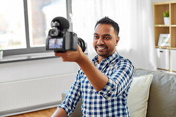 Image showing male video blogger with camera blogging at home