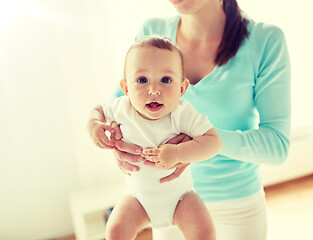 Image showing happy young mother with little baby at home