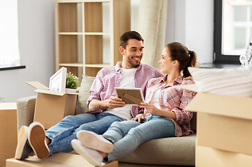 Image showing happy couple with boxes moving to new home