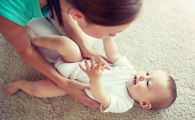 Image showing happy mother playing with baby at home