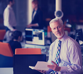 Image showing senior business man with his team at office