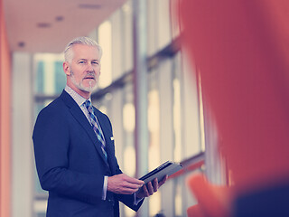 Image showing senior business man working on tablet computer