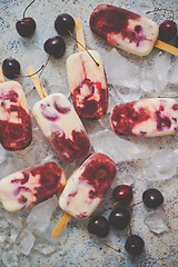 Image showing Delicious, homemade popsicles made from cherries and cream.