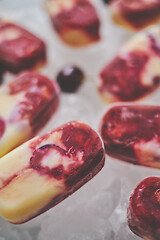 Image showing Delicious, homemade popsicles made from cherries and cream.