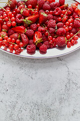 Image showing Fresh summer fruit composition. Strawberries, red currants, raspberries placed on metal tray