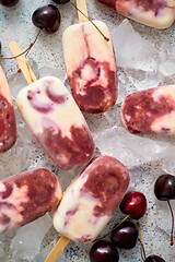 Image showing Delicious, homemade popsicles made from cherries and cream.