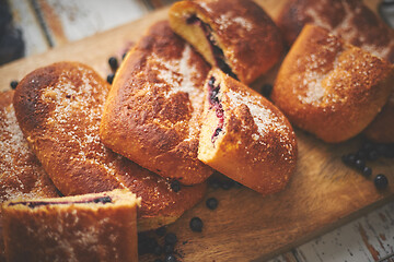 Image showing Tasty blueberry bun stuffed with fresh forrest fruits. Traditional polish bun called jagodzianka