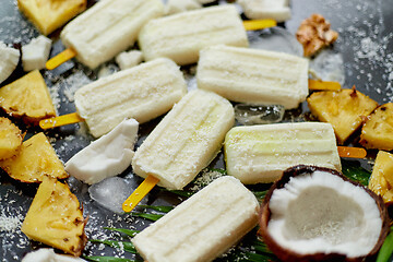 Image showing Homemade vegan popsicles made with coconut milk and pineapple. Delicious healthy summer snack