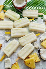 Image showing Summer popsicles on stick. Pinacolada flavour. Made with pineapple, cocount milk, rum. Vegan snack