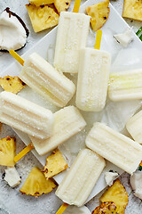 Image showing Homemade vegan popsicles made with coconut milk and pineapple. Delicious healthy summer snack