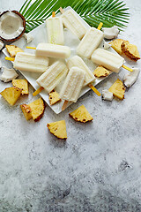 Image showing Summer popsicles on stick. Pinacolada flavour. Made with pineapple, cocount milk, rum. Vegan snack