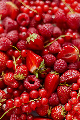 Image showing Fresh summer red fruit background composition. Strawberries, red currants, raspberries.