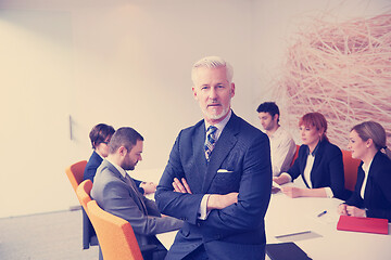 Image showing senior business man with his team at office