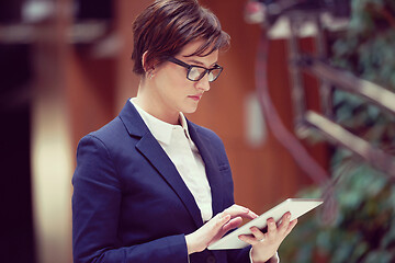 Image showing business woman working on tablet