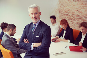 Image showing senior business man with his team at office