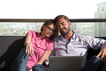 Image showing couple relaxing at  home using laptop computers