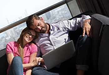 Image showing couple relaxing at  home using laptop computers