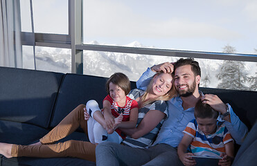 Image showing happy young couple spending time with kids at home