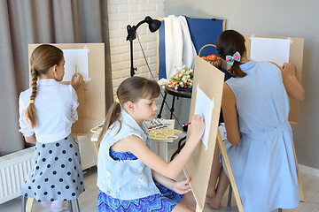 Image showing classes in the art studio behind the easels of children and adul