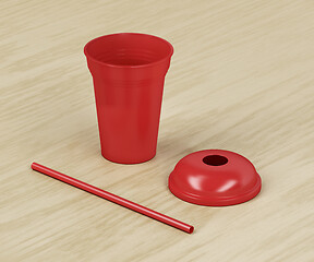 Image showing Red disposable plastic cup and straw