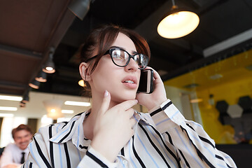 Image showing portrait of businesswoman with glasses using mobile phone