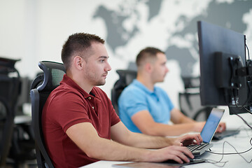 Image showing two male software developers working on computer