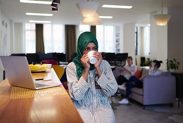 Image showing african muslim business woman drinking tea