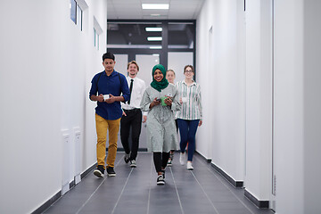 Image showing multi-ethnic startup business team walking through the hallway