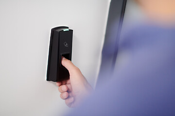 Image showing man pressing fingerprint scanner