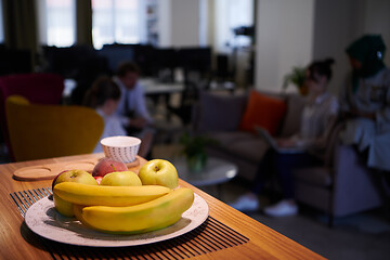 Image showing a bowl of fresh fruits at modern startup office