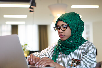 Image showing african muslim business woman working on laptop computer