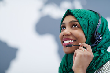 Image showing African muslim female with phone headset helping and supporting 