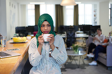 Image showing african muslim business woman drinking tea