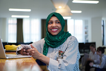 Image showing african muslim business woman using mobile phone