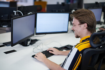 Image showing casual business man working on desktop computer