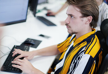 Image showing casual business man working on desktop computer