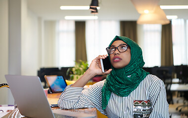 Image showing african muslim business woman using mobile phone