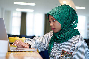 Image showing african muslim business woman working on laptop computer