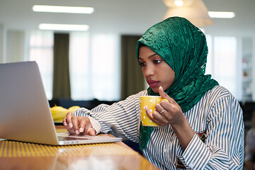 Image showing african muslim business woman drinking tea